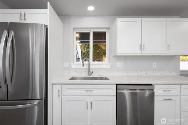 a kitchen with a refrigerator and window