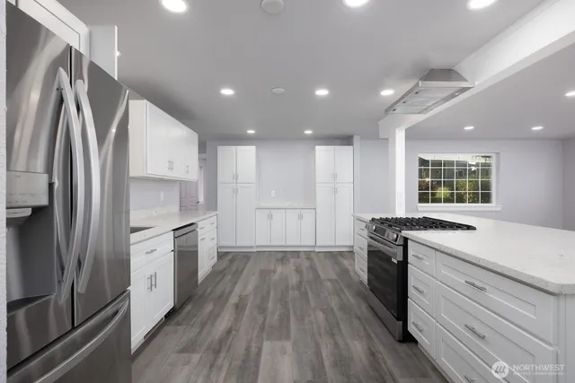 a kitchen with a sink stainless steel appliances and cabinets