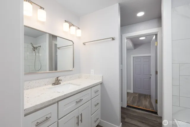 a bathroom with a shower sink and mirror