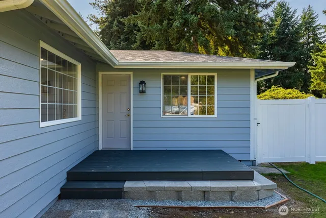 a view of house with backyard outdoor seating and entertaining space