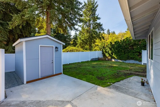 a view of backyard of house with green space