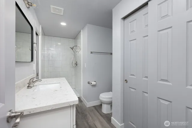 a bathroom with a sink toilet and shower