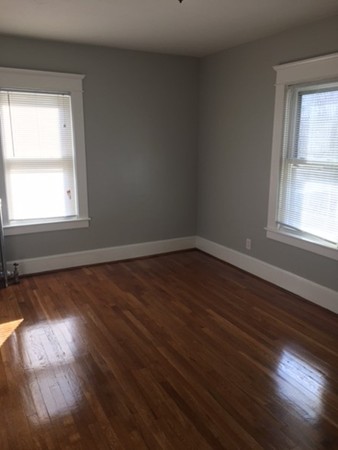 78 Fresno Street Springfield, MA 01104 - Photo 8 of 17 an empty room with wooden floor and windows