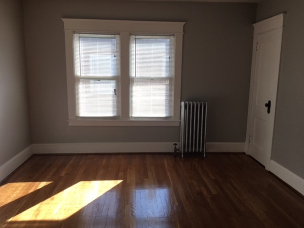 78 Fresno Street Springfield, MA 01104 - Photo 9 of 17 an empty room with wooden floor and windows