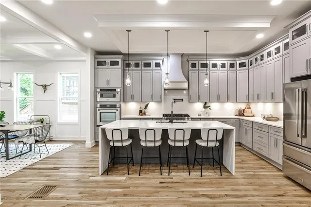 a large kitchen with a table and chairs