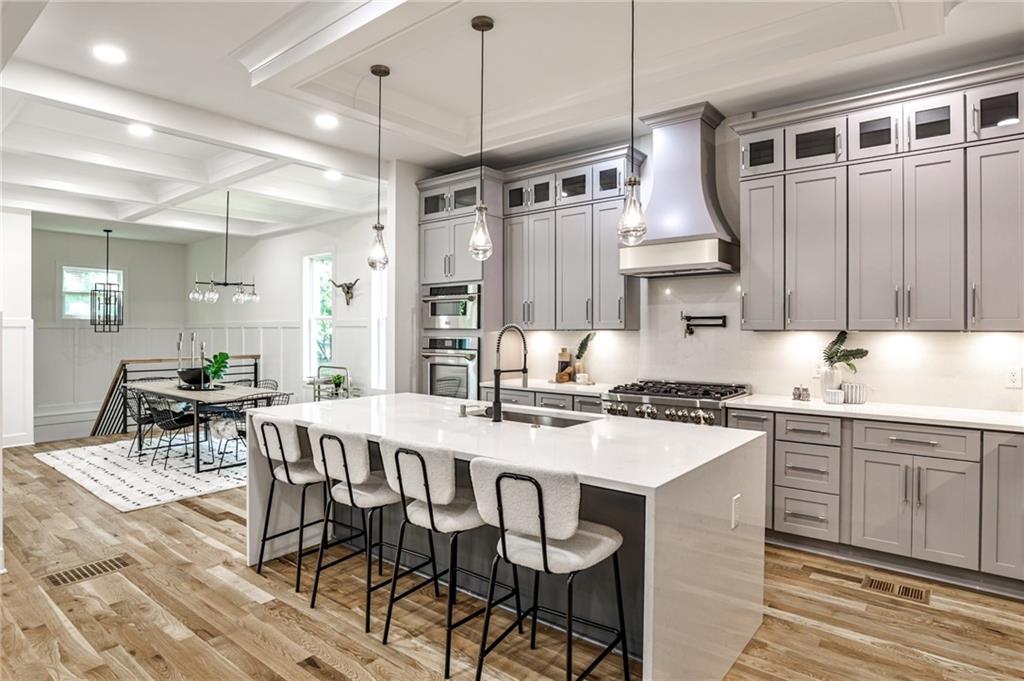 1401 Rupert Road Decatur, GA 30030 - Photo 13 of 43 a kitchen with stainless steel appliances granite countertop a stove a sink dishwasher and a refrigerator with wooden floor