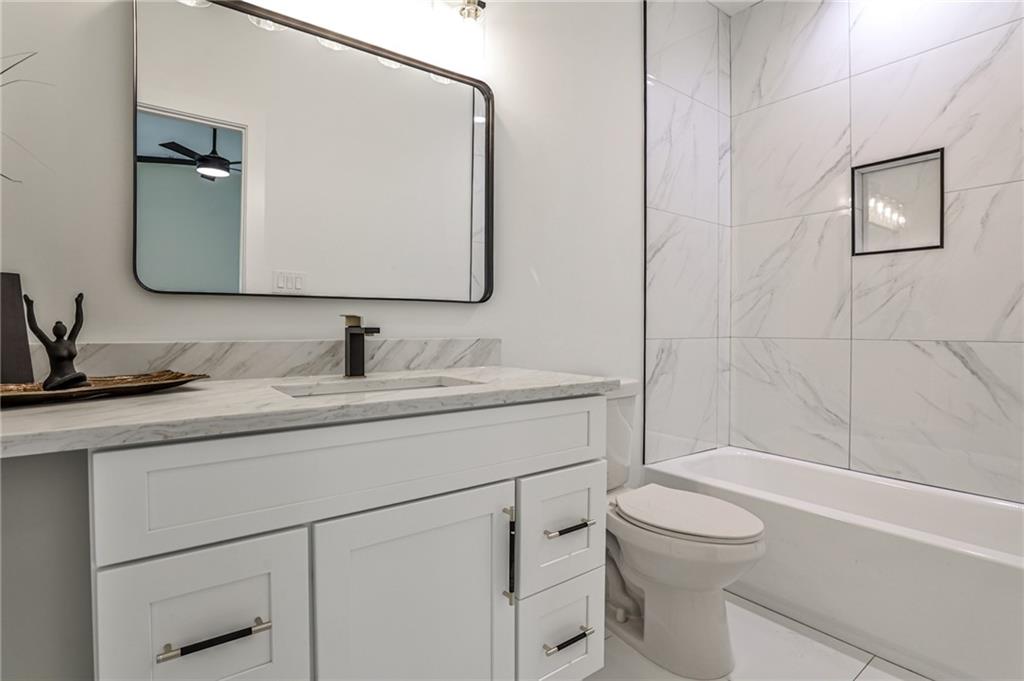 1401 Rupert Road Decatur, GA 30030 - Photo 27 of 43 a bathroom with a granite countertop sink toilet and shower