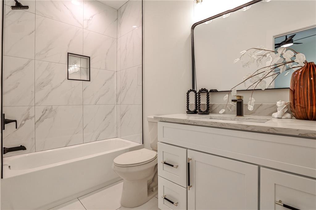 1401 Rupert Road Decatur, GA 30030 - Photo 29 of 43 a bathroom with a granite countertop sink a toilet and bathtub