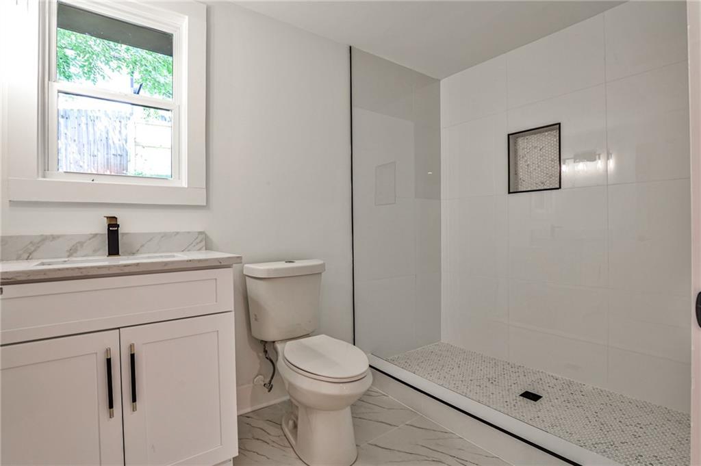 1401 Rupert Road Decatur, GA 30030 - Photo 35 of 43 a bathroom with a sink a toilet and shower