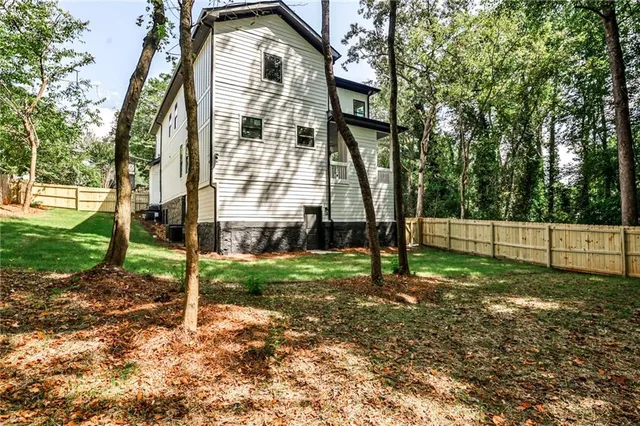 a view of a house with a yard and sitting area