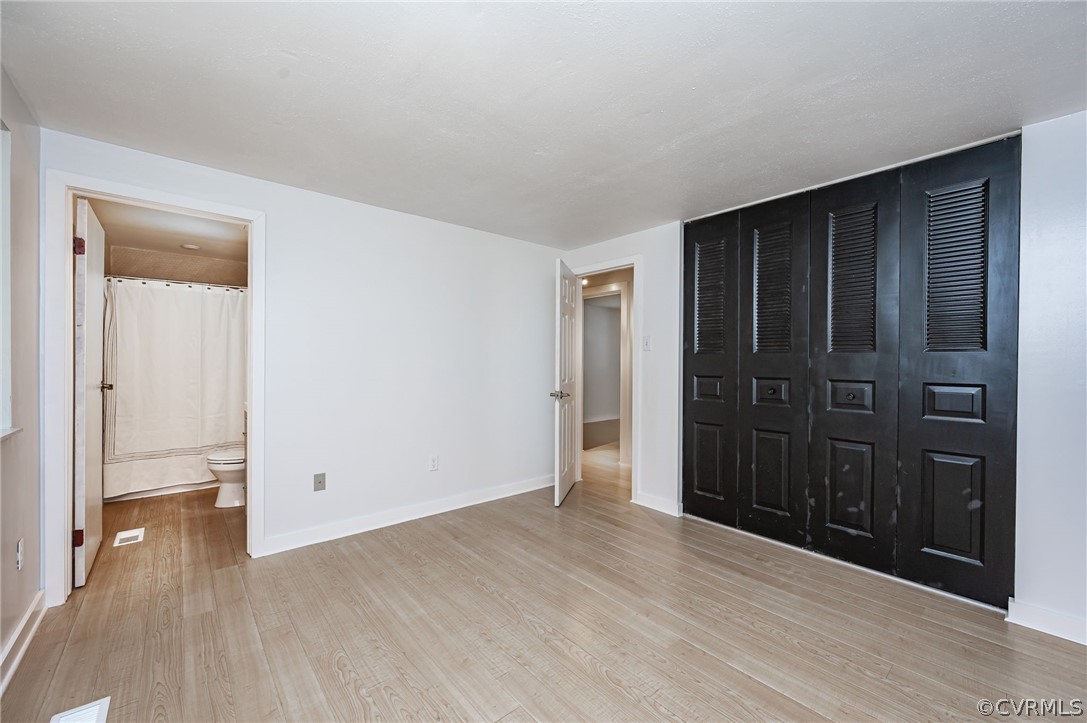 10523 White Rabbit Road North Chesterfield, VA 23235 - Photo 12 of 23 an empty room with wooden floor closet and windows