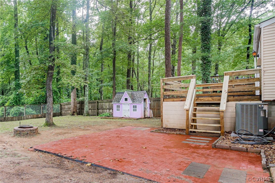 10523 White Rabbit Road North Chesterfield, VA 23235 - Photo 17 of 23 a backyard of a house with barbeque oven and wooden fence