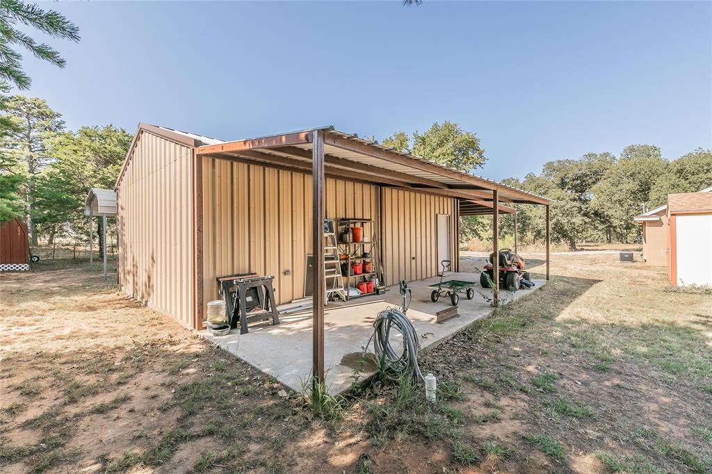a view of a backyard with sitting area