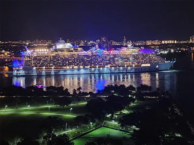 a living room with furniture a chandelier and a flat screen tv