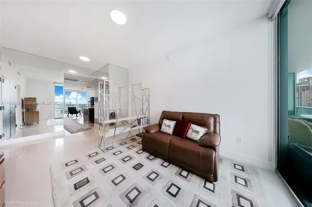 a bedroom with a bed and large window