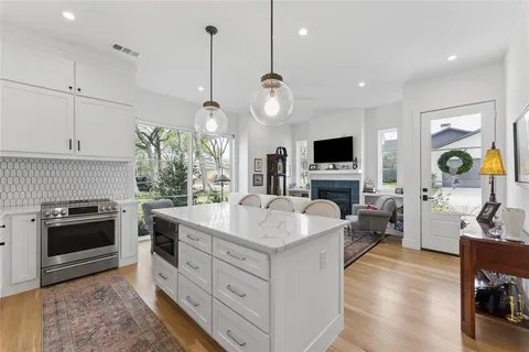 a kitchen with sink stove and refrigerator