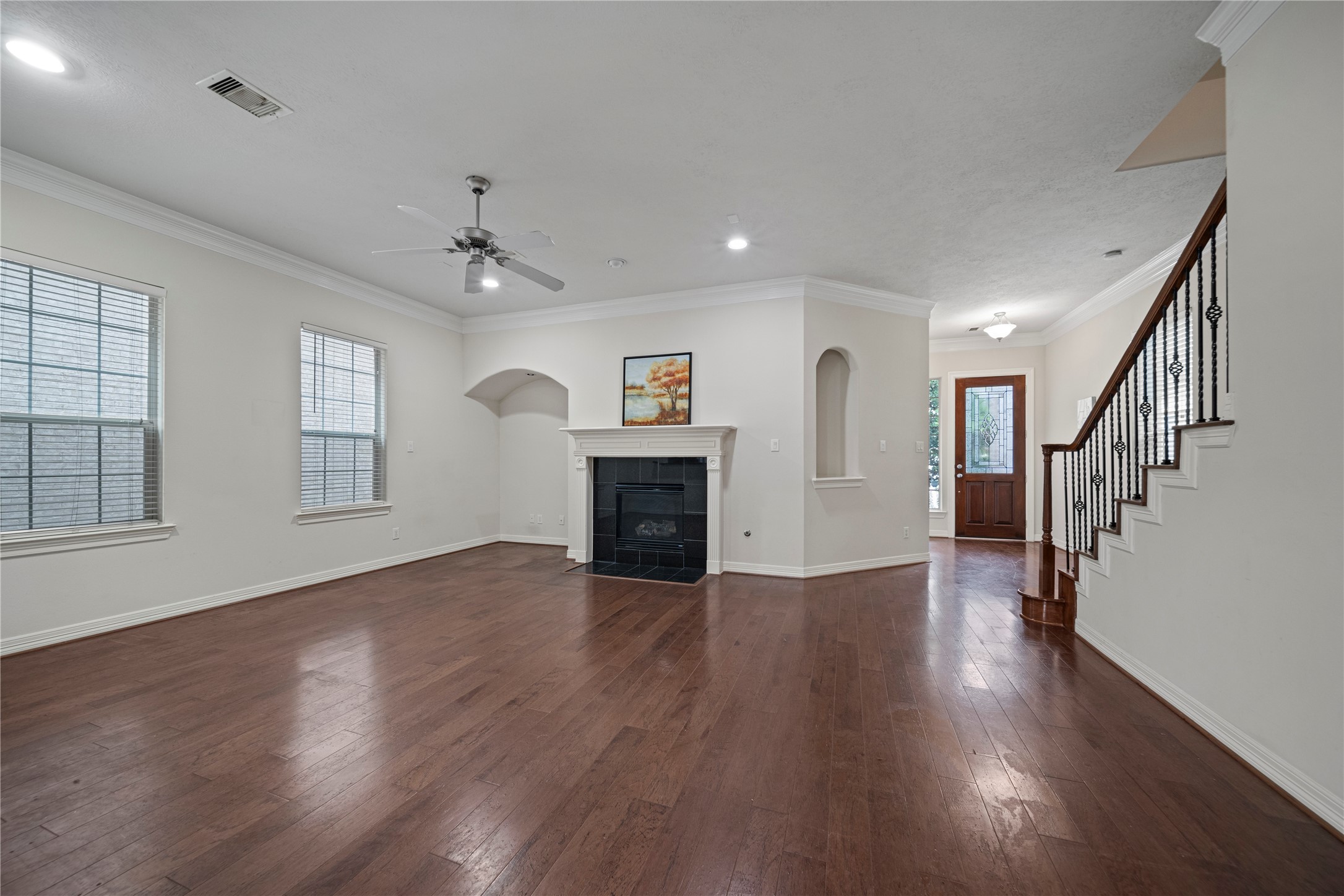14443 Basalt Lane Houston, TX 77077 - Photo 11 of 39 an empty room with wooden floor fireplace and windows