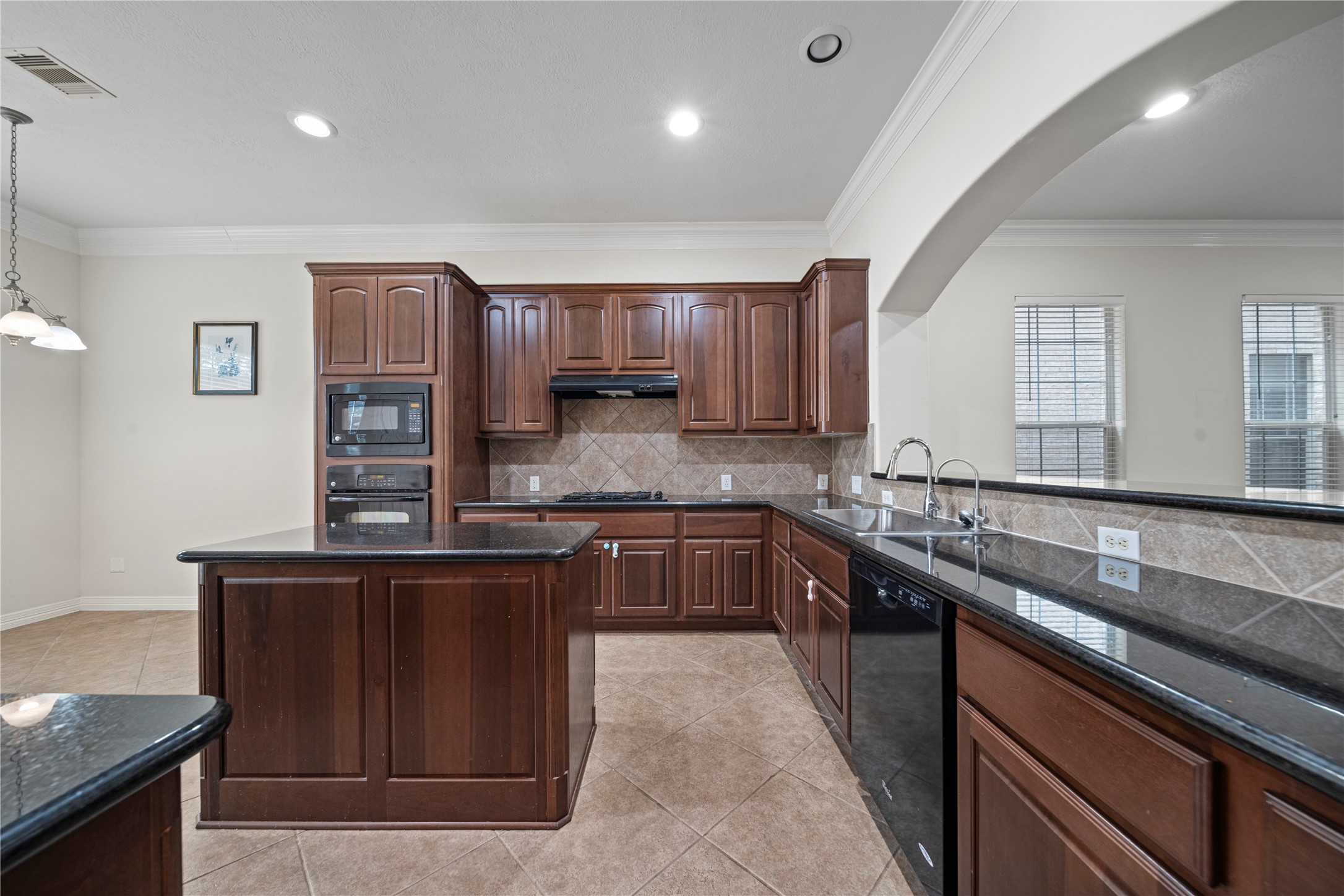 14443 Basalt Lane Houston, TX 77077 - Photo 12 of 39 a kitchen with stainless steel appliances granite countertop a sink wooden cabinets and a granite counter tops