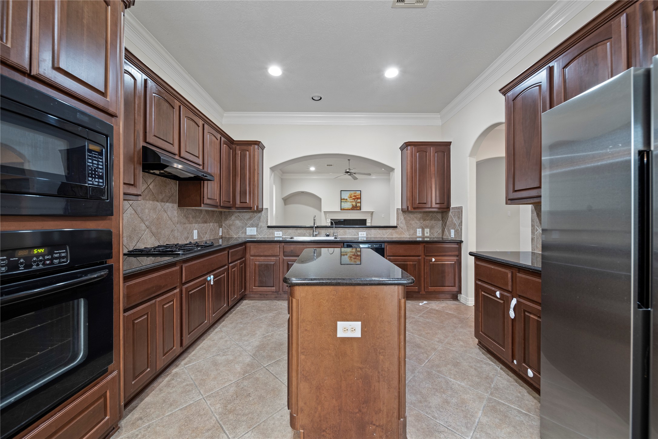 14443 Basalt Lane Houston, TX 77077 - Photo 13 of 39 a kitchen with stainless steel appliances granite countertop a stove top oven a sink and dishwasher