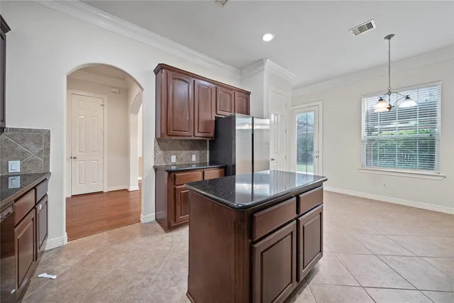 a kitchen with kitchen island cabinets a sink appliances and a counter top space