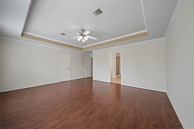 a view of an empty room with wooden floor