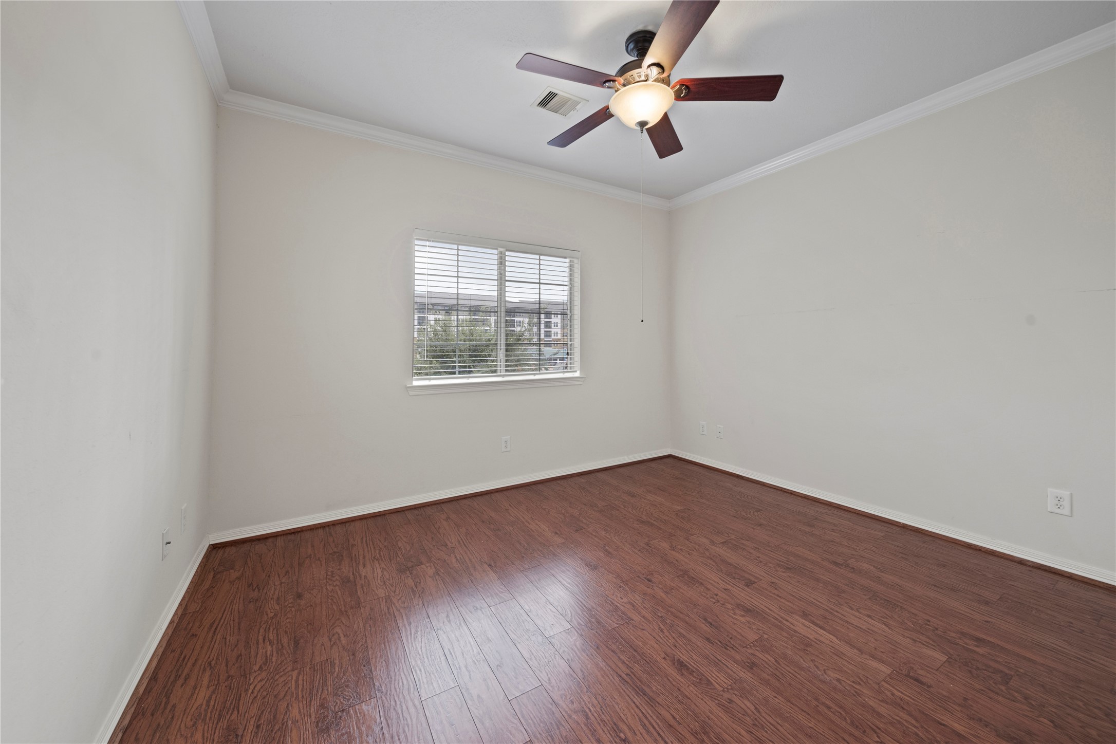 14443 Basalt Lane Houston, TX 77077 - Photo 20 of 39 an empty room with wooden floor fan and windows
