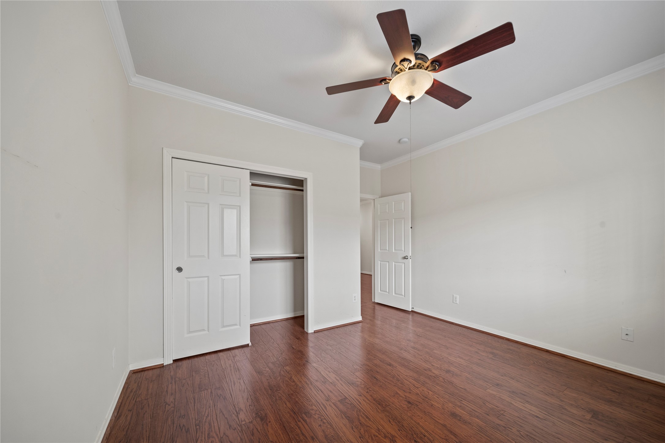 14443 Basalt Lane Houston, TX 77077 - Photo 26 of 39 an empty room with wooden floor ceiling fan and window