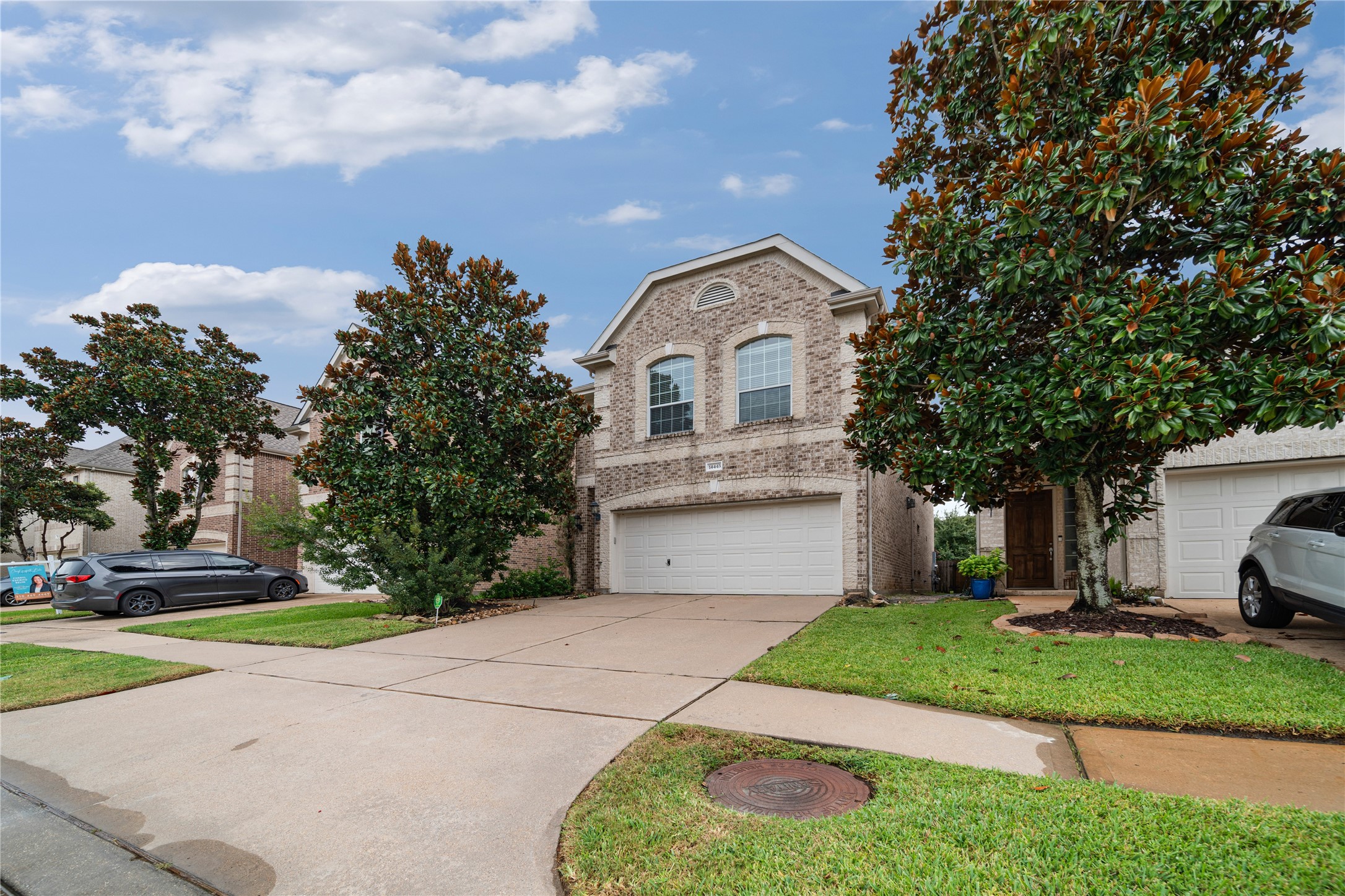 14443 Basalt Lane Houston, TX 77077 - Photo 3 of 39 a view of a white house with a small yard plants and a large tree