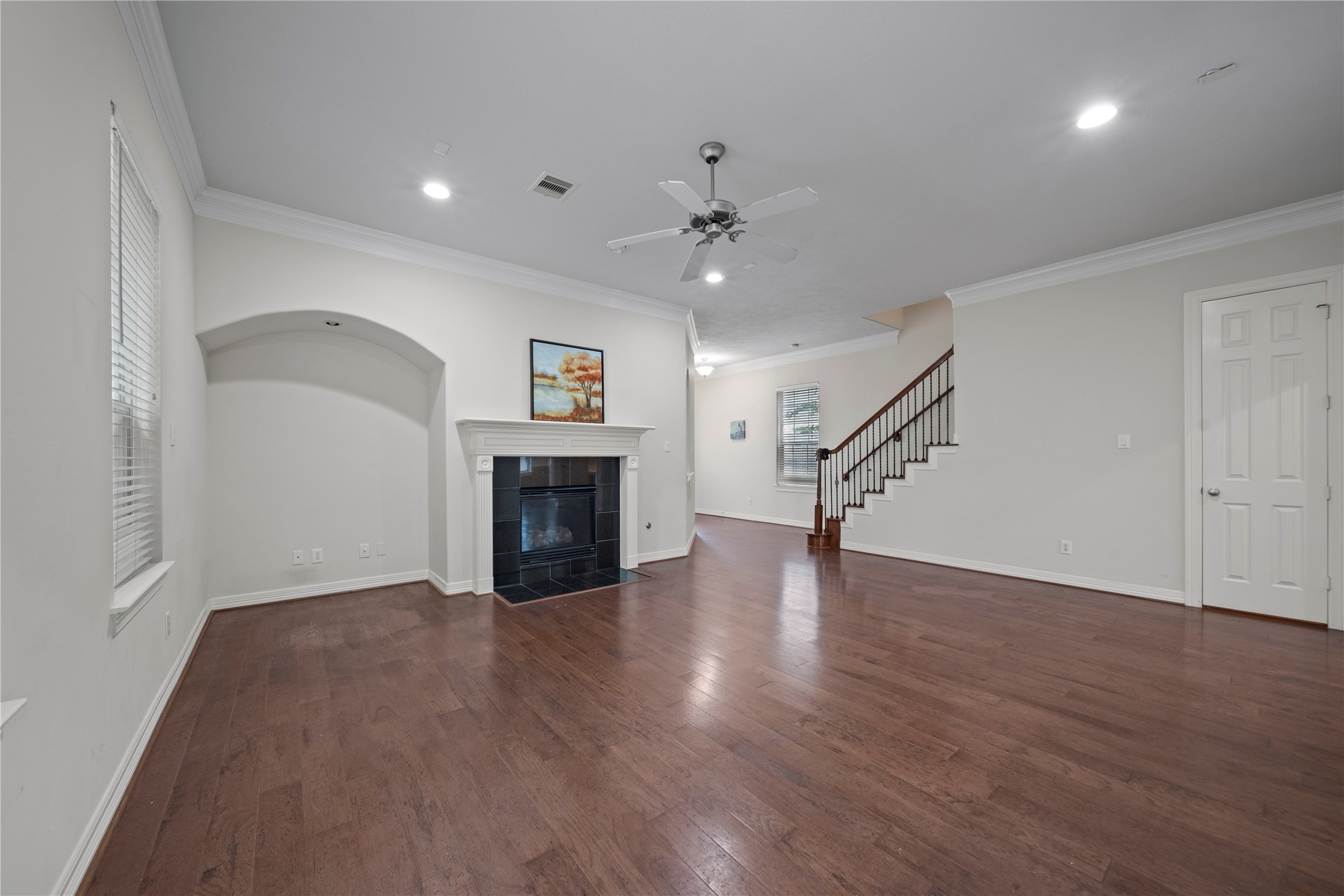 14443 Basalt Lane Houston, TX 77077 - Photo 9 of 39 a view of empty room with wooden floor and fireplace