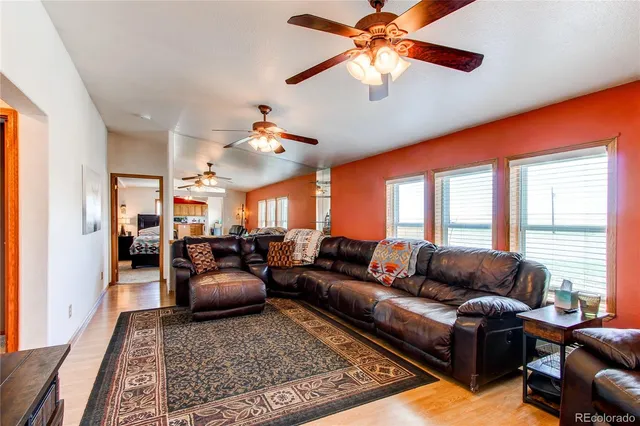 a kitchen with stainless steel appliances granite countertop wooden floors and white cabinets