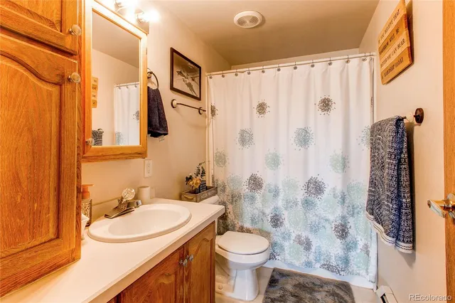 a living room with furniture a ceiling fan and a window