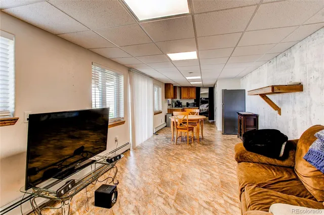 a living room with a bed furniture and a large window
