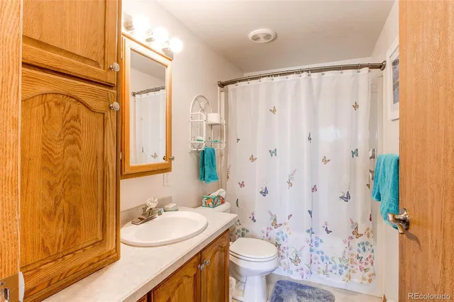 a bedroom with a bed and a lamp on the dresser