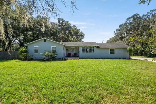 a front view of house with yard and trees