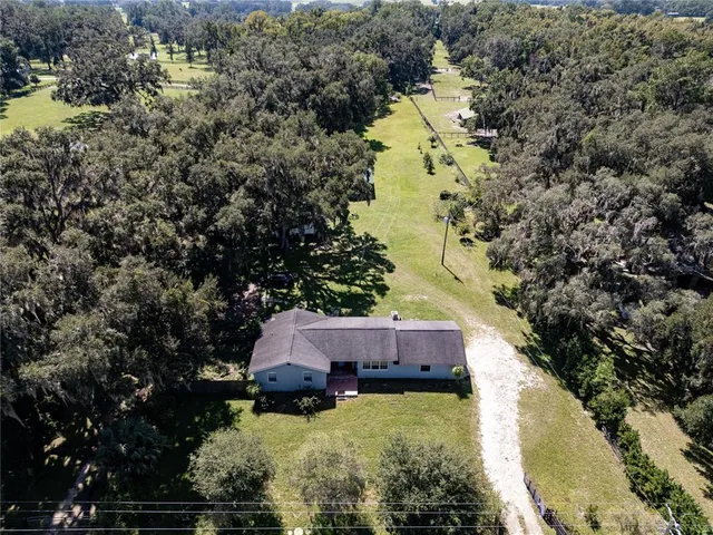 a house with swimming pool in front of it