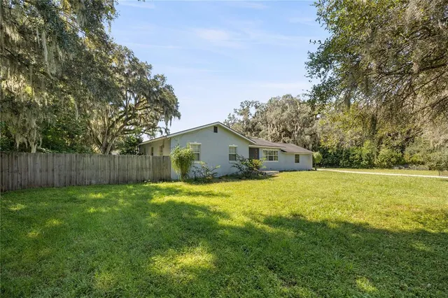 a front view of house with yard and trees