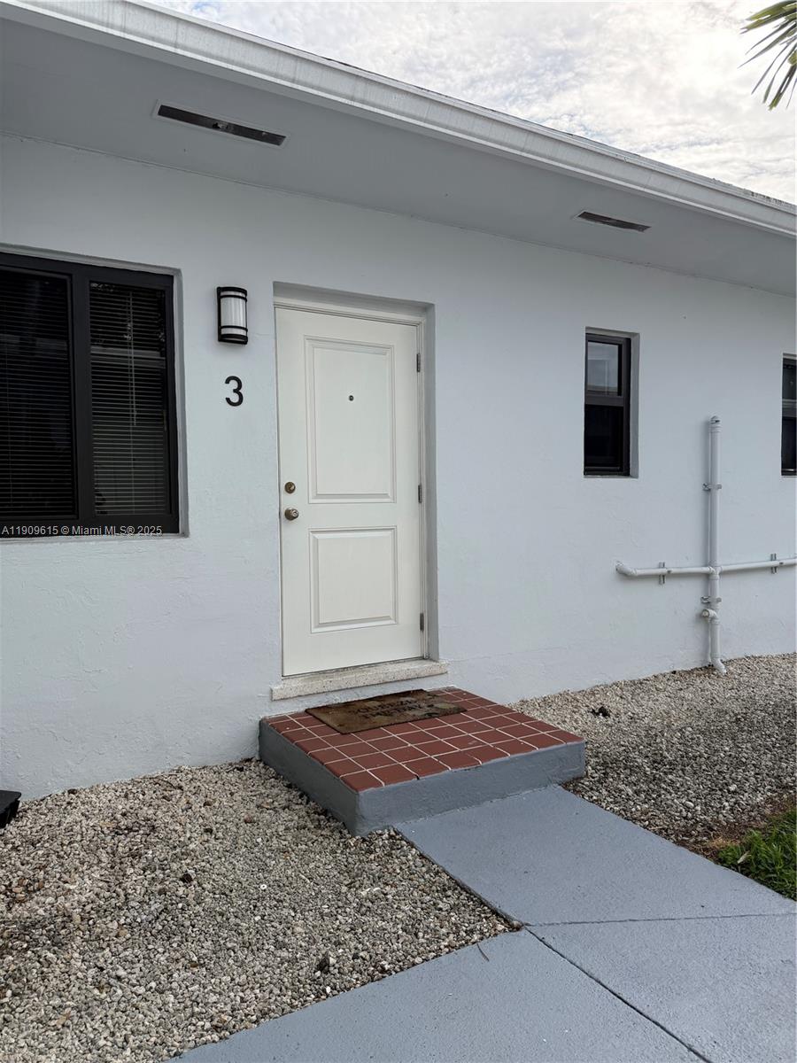 600 Southwest 10th Street, Unit 3 Miami, FL 33130 - Photo 13 of 17 a bedroom with a bed and a flat screen tv