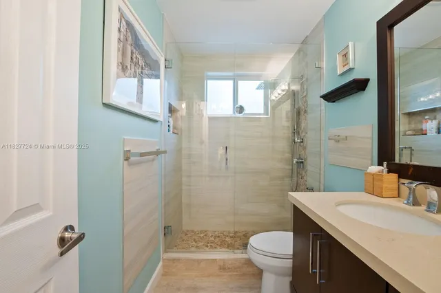 a bathroom with a sink toilet and shower