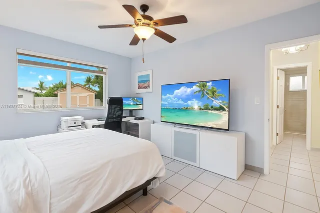 a bedroom with a bed and a large window