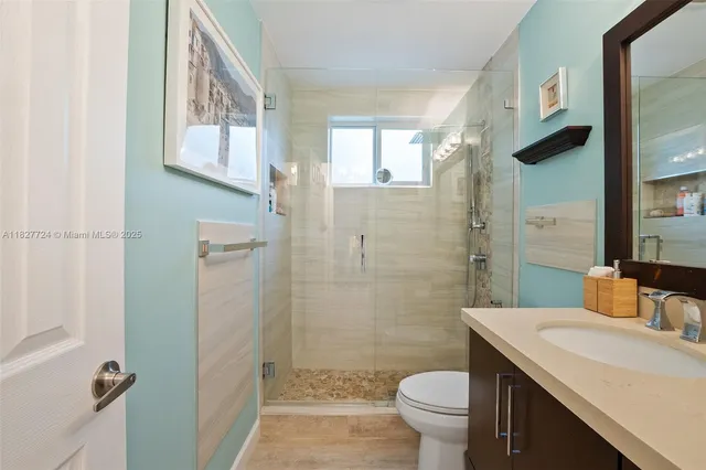 a bathroom with a sink toilet and shower