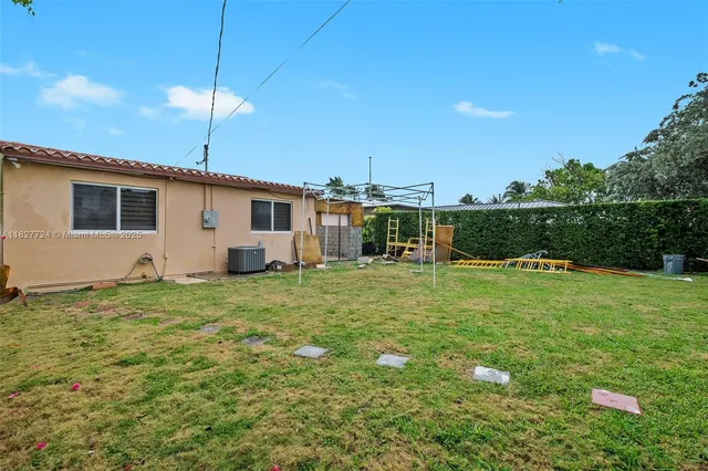 a view of a backyard with plants and patio