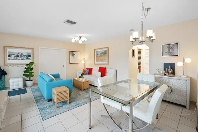a living room with furniture and kitchen view
