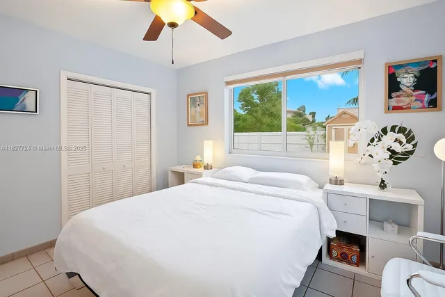 a bedroom with a bed and a potted plant