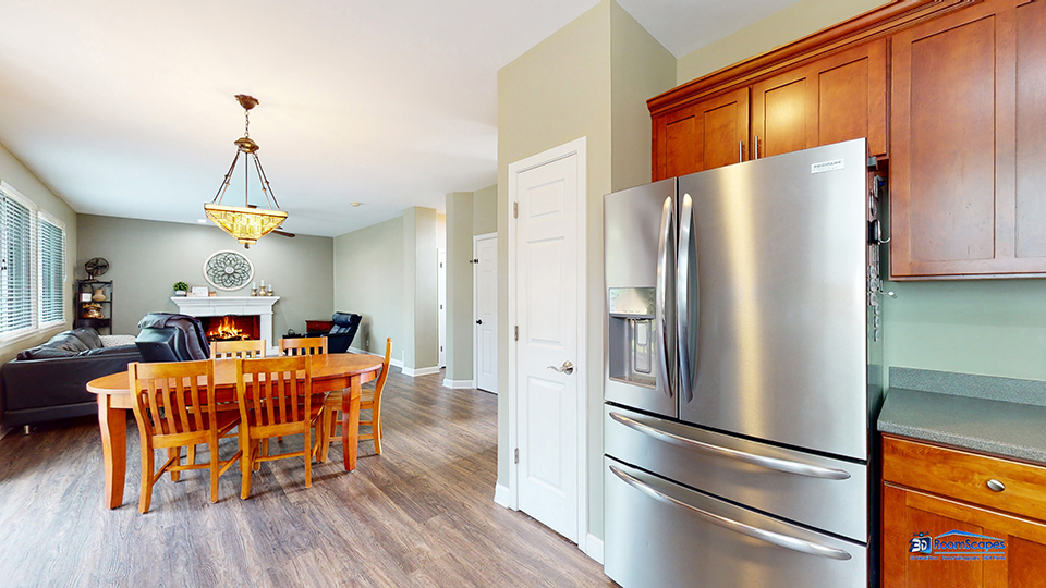 788 North Overlook Trail Round Lake, IL 60073 - Photo 11 of 45 a kitchen with stainless steel appliances granite countertop a refrigerator oven a dining table and chairs with wooden floor