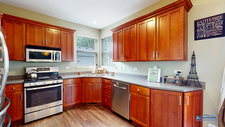 788 North Overlook Trail Round Lake, IL 60073 - Photo 9 of 45 a kitchen with stainless steel appliances granite countertop stove a sink dishwasher and a microwave