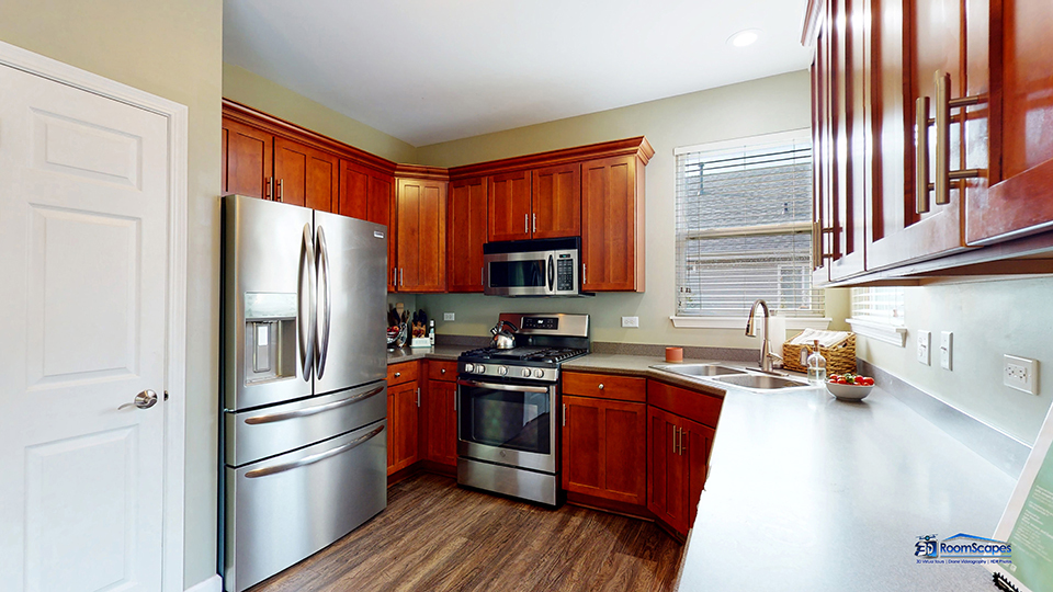 788 North Overlook Trail Round Lake, IL 60073 - Photo 10 of 45 a kitchen with stainless steel appliances granite countertop a refrigerator a sink dishwasher a stove with wooden cabinets and floor