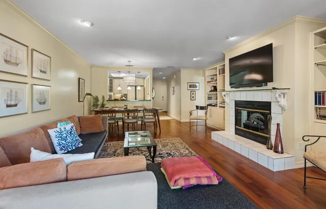 a living room with furniture flat screen tv and a fireplace