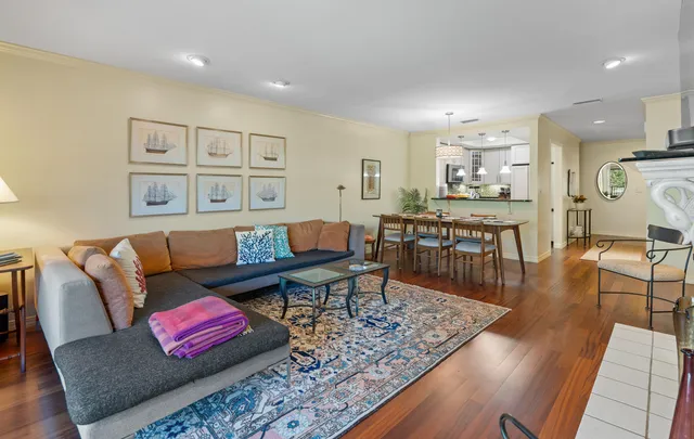 a living room with furniture and wooden floor