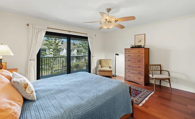a bedroom with a bed a chandelier and a window