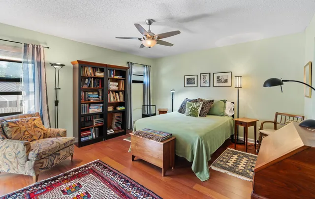 a bed room with a bed and a book shelf
